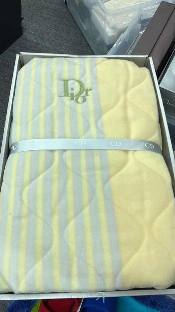 Authentic Dior Blanket - Yellow & Grey Stripes (Category: Bedding & Towels) located in Valenzuela. Submitted by micahdamias_finds (Listing ID 1446714678, Image 1). Description: - Authentic Dior blanket - Features iconic embroidered Dior logo - Soft material with yellow and grey striped pattern - Includes original box and CD ribbon - Bought in Japan.