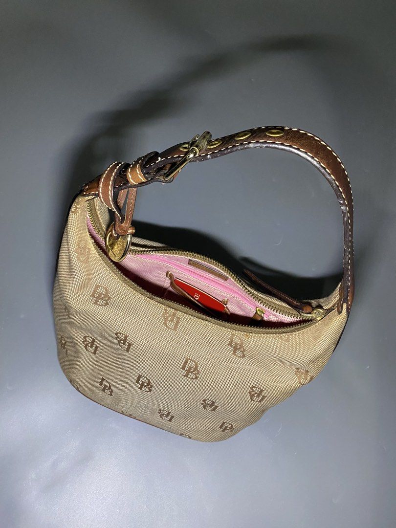 Dooney & Bourke (NEGOTIABLE AND AUTHENTIC (Category: Luxury Bags & Wallets) located in San Jose del Monte. Submitted by kidfromnclb (Listing ID 1446642855, Image 1). Description: - Classic Dooney & Bourke hobo bag - Tan canvas with all-over DB monogram print - Brown leather trim and strap - Interior features a vibrant pink lining - Secure zipper closure - Ideal everyday bag - no issue - all zippers working - Authentic.