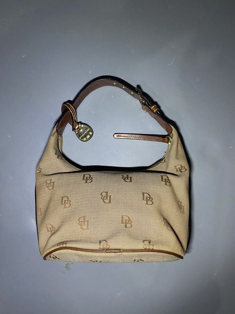 Dooney & Bourke (NEGOTIABLE AND AUTHENTIC (Category: Luxury Bags & Wallets) located in San Jose del Monte. Submitted by kidfromnclb (Listing ID 1446642855, Image 3). Description: - Classic Dooney & Bourke hobo bag - Tan canvas with all-over DB monogram print - Brown leather trim and strap - Interior features a vibrant pink lining - Secure zipper closure - Ideal everyday bag - no issue - all zippers working - Authentic.