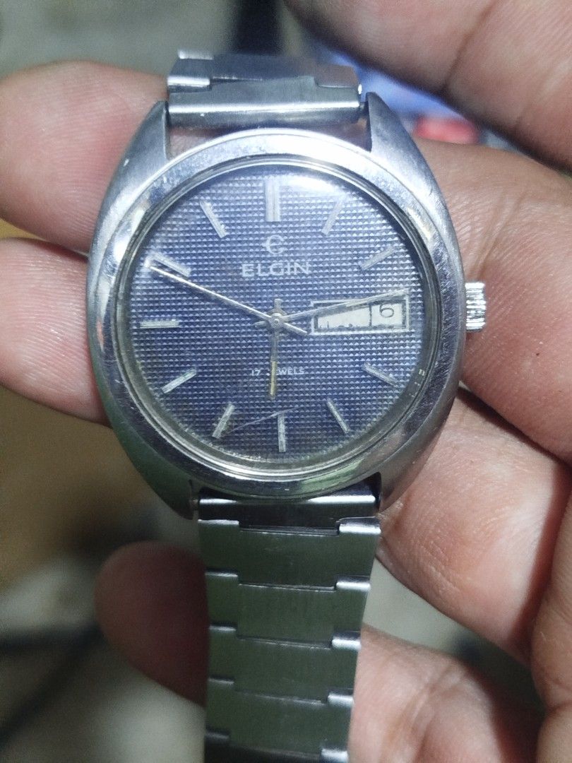 1970s Elgin Watch manual winding (Category: Men's Watches) located in Subic. Submitted by regiedaniel01 (Listing ID 1446637683, Image 1). Description: - Vintage Elgin Automatic Watch - Stainless Steel Case & Bracelet - Striking Blue Dial - Day & Date Complication - 21 Jewels Movement - Excellent Running Condition - Perfect for Watch Collectors.