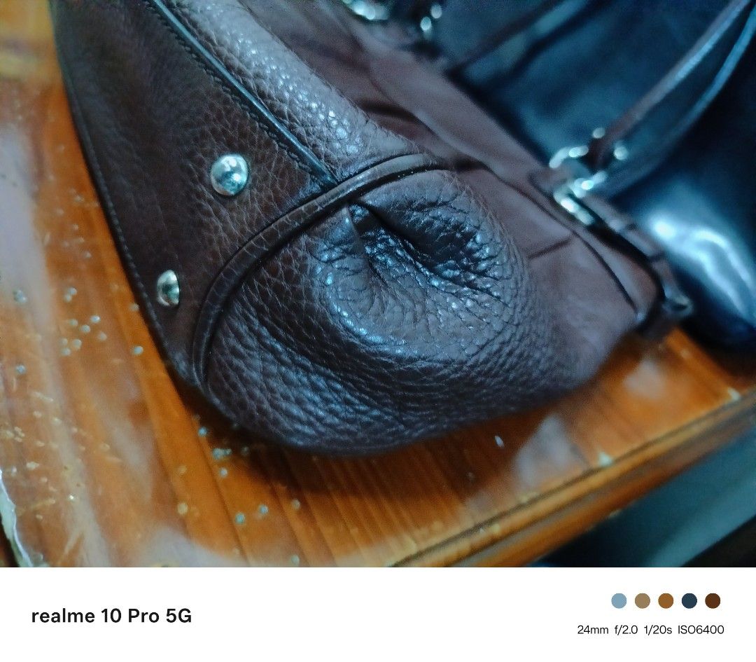 Ferragamo Brown Leather Shoulder Bag (Category: Shoulder Bags) located in Manila. Submitted by cleverturtle-2982 (Listing ID 1446622602, Image 3). Description: - Stylish brown pebbled leather shoulder bag - Features decorative buckle details on the sides - Double handles for comfortable carrying - Ample interior space for all your essentials - Ideal for everyday use - Shows some signs of wear, but remains in good overall shape.
