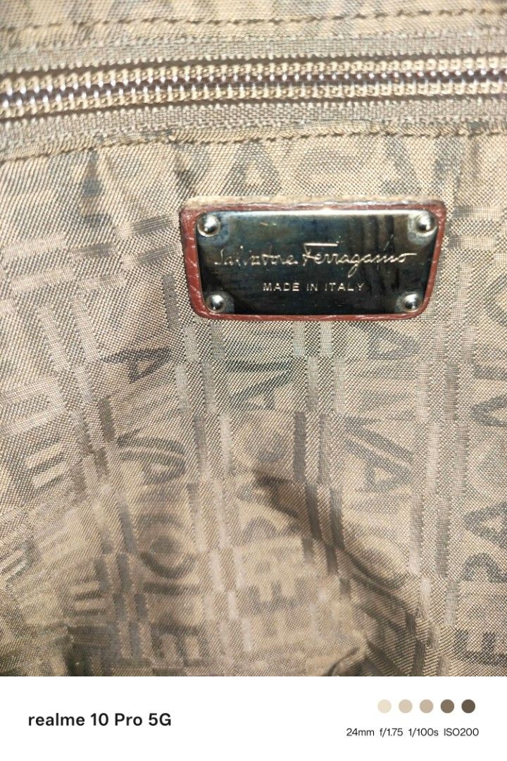 Ferragamo Brown Leather Shoulder Bag (Category: Shoulder Bags) located in Manila. Submitted by cleverturtle-2982 (Listing ID 1446622602, Image 1). Description: - Stylish brown pebbled leather shoulder bag - Features decorative buckle details on the sides - Double handles for comfortable carrying - Ample interior space for all your essentials - Ideal for everyday use - Shows some signs of wear, but remains in good overall shape.