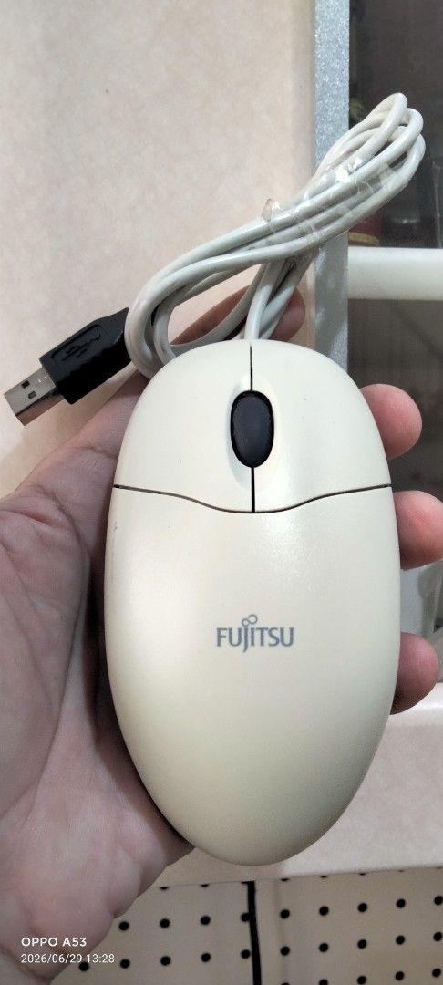 Fujitsu Wired USB Optical Mouse (Category: Mouse & Mousepads) located in Binan City. Submitted by rpute (Listing ID 1446581682, Image 1). Description: - Fujitsu wired optical mouse - Cream color with dark grey sides - USB connection - Simple plug and play functionality - Works well for everyday computer use.