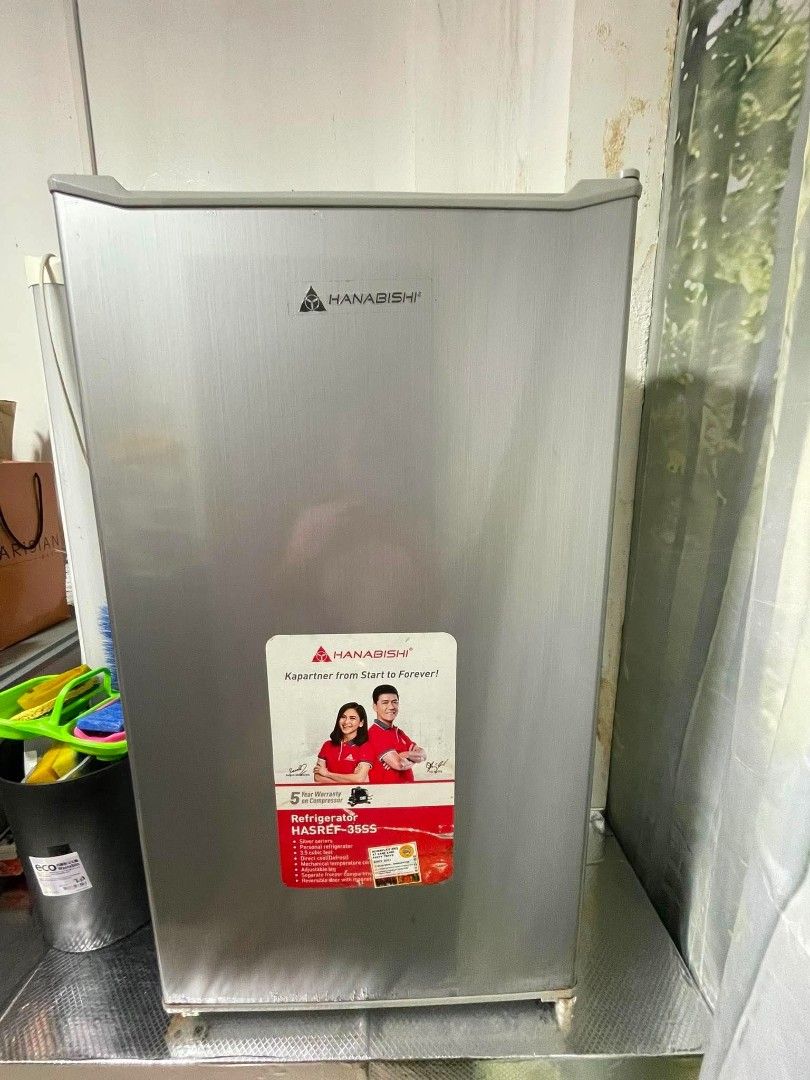 Hanabishi Single Door Refrigerator HASREF35SS (Category: Refrigerators and Freezers) located in Manila. Submitted by beaberry03 (Listing ID 1446582779, Image 2). Description: - Hanabishi HASREF35SS Single Door Refrigerator - Color: Silver - Features shelves and door compartments - Still in working condition - Minor rust visible on bottom edges - Ideal for small spaces Stainless steel silver finish Personal refrigerator 3.5 cubic feet Direct Cool 