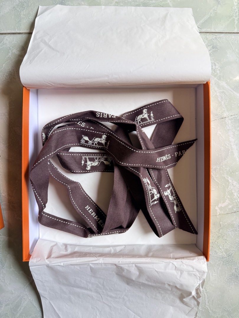 Hermes Paris Orange Box with Branded Ribbon (Category: Luxury Accessories) located in General Santos City (Dadiangas). Submitted by ssssshhhhhhhhh (Listing ID 1446568255, Image 2). Description: Original Hermes Paris orange box. Comes with the iconic Hermes ribbon. Ribbon has the horse and carriage motif. Perfect for gifting or storing small luxury items. Selling as is..