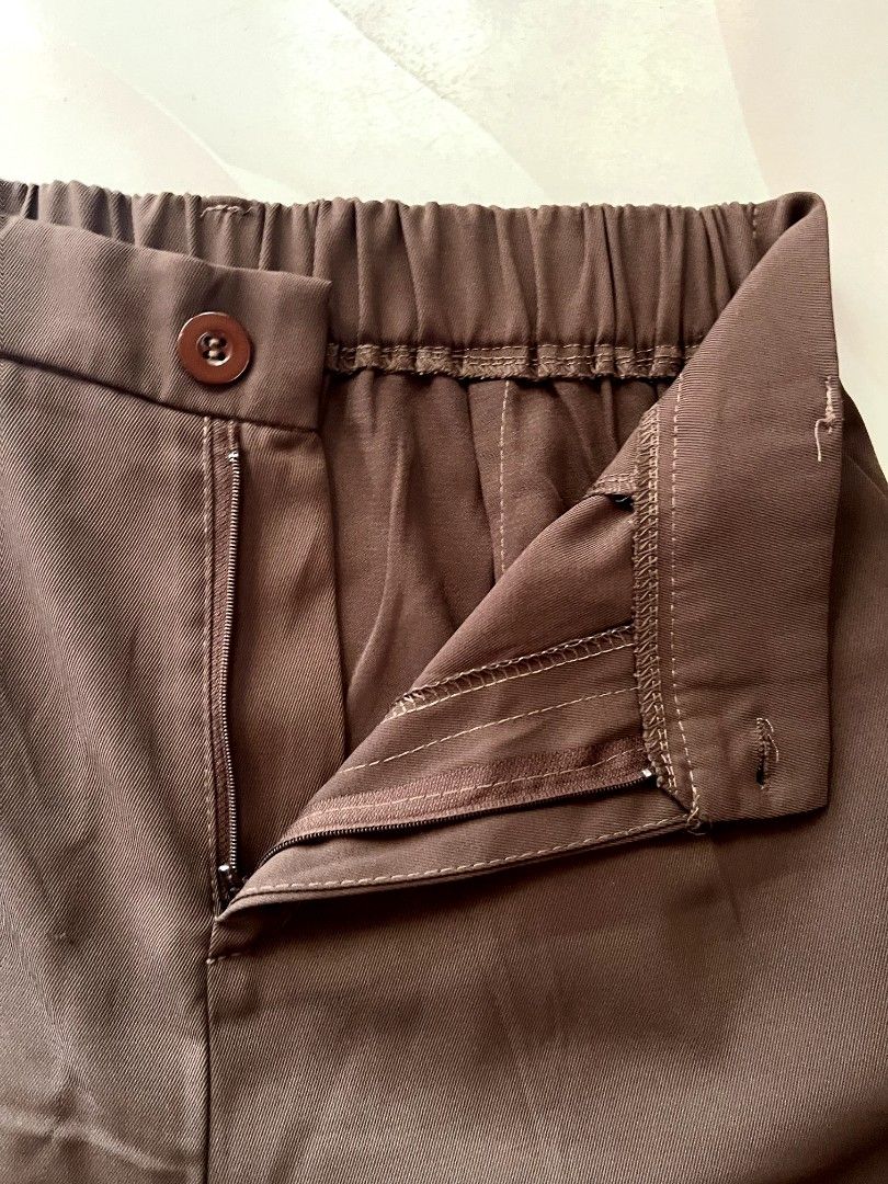 Ice Silk Brown Trouser Pants (Category: Other Bottoms) located in Lingayen. Submitted by kat_declutter (Listing ID 1446553064, Image 2). Description: - Choco Brown pants - Elastic waistband at the back, fits 27-30 inches |38 inches length - Button and zip closure at the front - Pleated detail on the front - Hemmed cuffs - Comfortable for everyday wear.