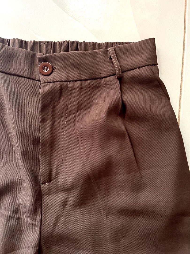 Ice Silk Brown Trouser Pants (Category: Other Bottoms) located in Lingayen. Submitted by kat_declutter (Listing ID 1446553064, Image 3). Description: - Choco Brown pants - Elastic waistband at the back, fits 27-30 inches |38 inches length - Button and zip closure at the front - Pleated detail on the front - Hemmed cuffs - Comfortable for everyday wear.