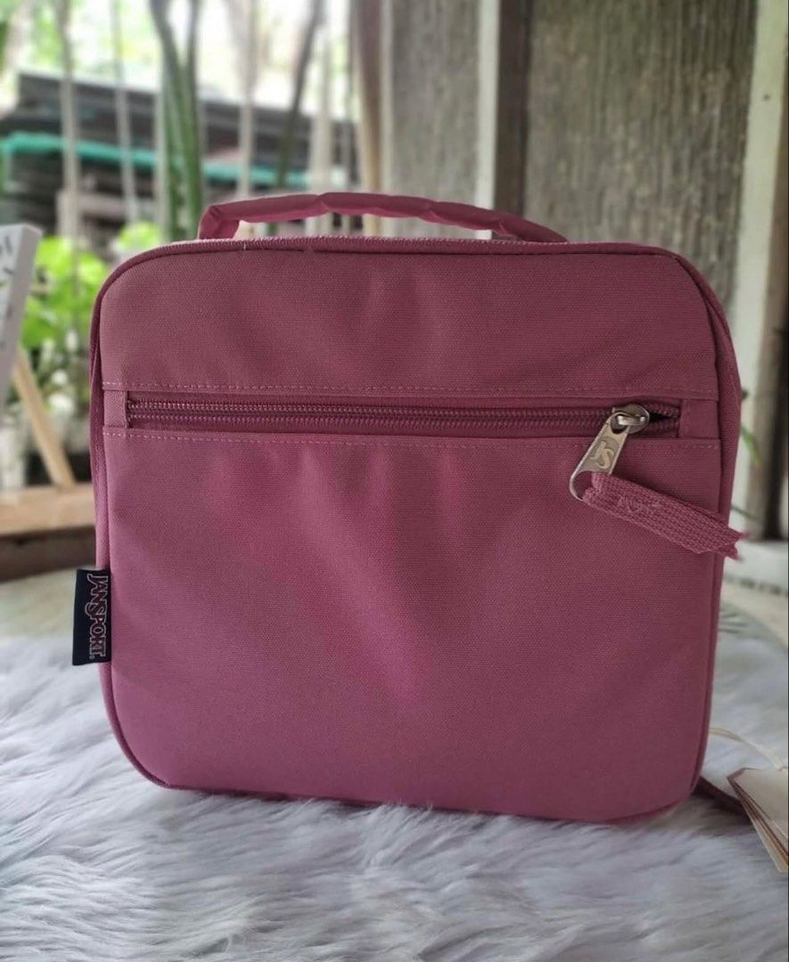 JanSport Pink Lunch Bag (Category: Other Babies Going Out Needs) located in Imus. Submitted by luxefad (Listing ID 1446572980, Image 1). Description: - Pink JanSport lunch bag - Features a convenient front zipper pocket - Easy to carry with a top handle - Made from durable material for long-lasting use - Ample interior space for your meals - Ideal for school or work lunches.