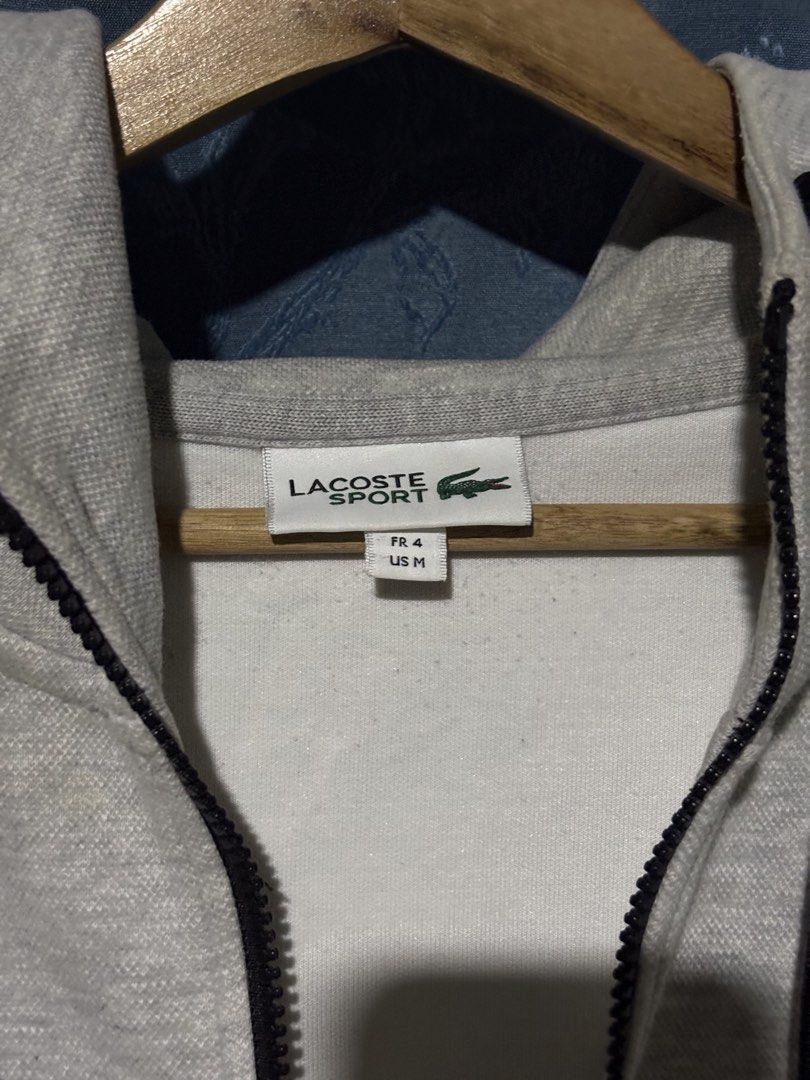 Lacoste Grey Zip-Up Hoodie (Category: Hoodies) located in Cebu City. Submitted by somewhereintime_ (Listing ID 1446659732, Image 3). Description: - Grey Lacoste zip-up hoodie - Signature crocodile logo on chest - Full zip closure - Front pockets - Attached hood - Ideal for casual wear.