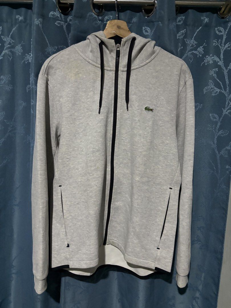 Lacoste Grey Zip-Up Hoodie (Category: Hoodies) located in Cebu City. Submitted by somewhereintime_ (Listing ID 1446659732, Image 1). Description: - Grey Lacoste zip-up hoodie - Signature crocodile logo on chest - Full zip closure - Front pockets - Attached hood - Ideal for casual wear.