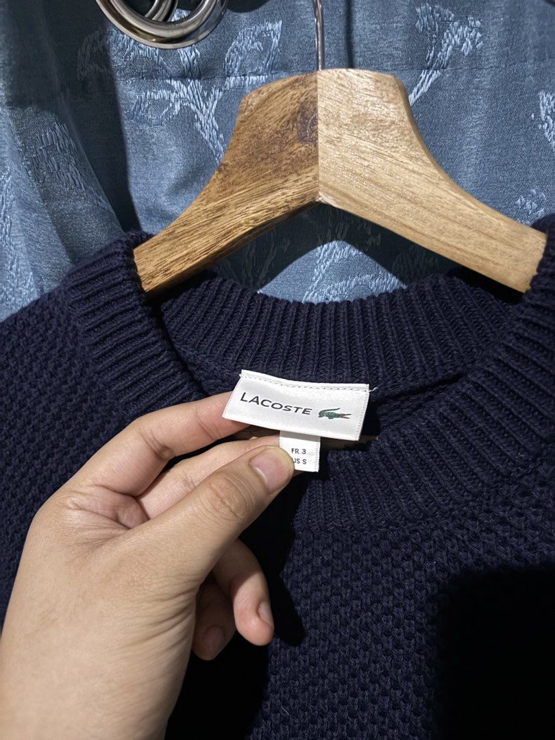 Lacoste Navy Blue Striped Knit Sweater (Category: Longsleeves) located in Cebu City. Submitted by somewhereintime_ (Listing ID 1446659652, Image 3). Description: - Navy blue Lacoste knit sweater - Features horizontal stripes in green and white across the chest - Classic crew neck design - Textured waffle-like knit pattern - Versatile for layering or standalone wear - Made in Japan.