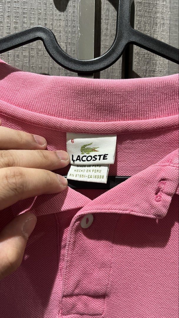 Lacoste Pink Polo Shirt Size 6 (Category: Tshirts & Polo Shirts ) located in Quezon City. Submitted by luissso_ (Listing ID 1446570558, Image 2). Description: - Pink Lacoste Polo Shirt - Size: 6 - Made in Peru - Classic short-sleeved design - Features a collar and button placket - Iconic embroidered Lacoste crocodile logo on chest - Ideal for casual wear.