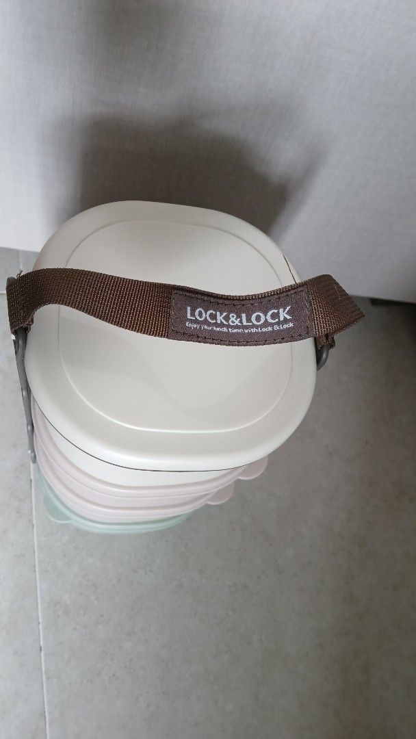 Lock & Lock Stackable Lunch Box with Strap (Category: Food Organisation & Storage) located in Singapore. Submitted by swiftcrystal.86e9fa (Listing ID 1446701340, Image 1). Description: - Stackable Lock & Lock lunch box 4 boxes (12cmx12cm) - Includes brown carrying strap.