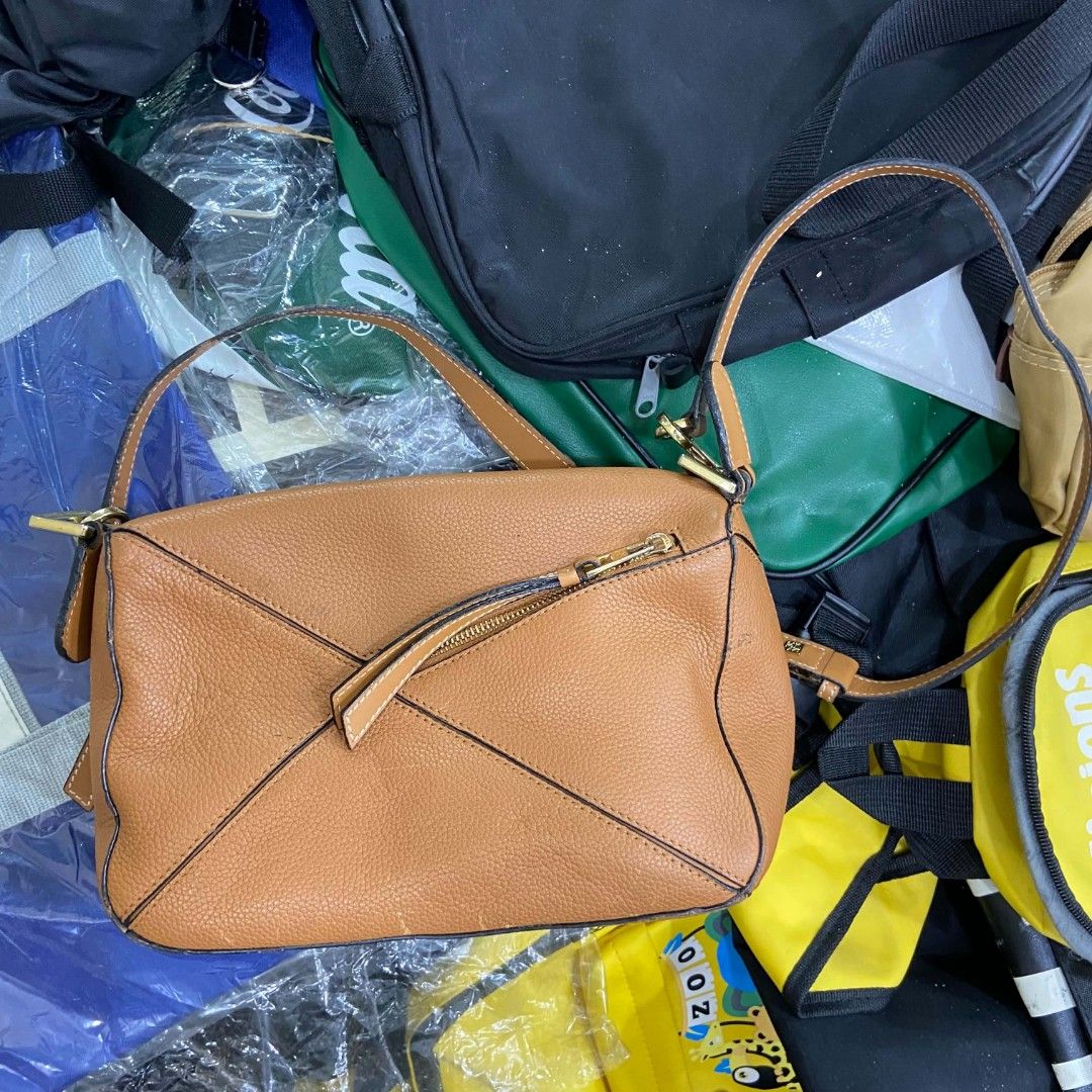 Loewe Puzzle Small Tan Leather Crossbody Bag (Category: Luxury Bags & Wallets) located in Bacolod City. Submitted by capitalismgoods6100 (Listing ID 1446580683, Image 2). Description: - Loewe Puzzle Bag - Small Size - Color: Tan - Material: Pebbled Leather - Hardware: Gold - Closure: Zipper - Interior: Fabric Lining - Origin: Made in Spain - Style: Great everyday bag.