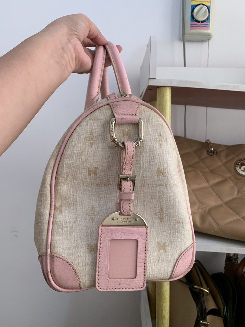 Metrocity Monogram and Pink Leather Boston Bag (Category: Luxury Bags & Wallets) located in Cavite. Submitted by Shin.Shoppe (Listing ID 1446570932, Image 3). Description: - Monogrammed canvas Boston bag - Pink leather trim and handles - All-over Metropolis logo pattern - Detachable luggage tag included - Zipper closure - Note: Some signs of wear on leather trim and corners.