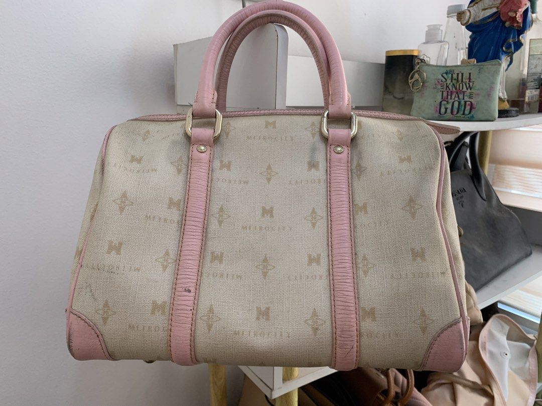 Metrocity Monogram and Pink Leather Boston Bag (Category: Luxury Bags & Wallets) located in Cavite. Submitted by Shin.Shoppe (Listing ID 1446570932, Image 2). Description: - Monogrammed canvas Boston bag - Pink leather trim and handles - All-over Metropolis logo pattern - Detachable luggage tag included - Zipper closure - Note: Some signs of wear on leather trim and corners.