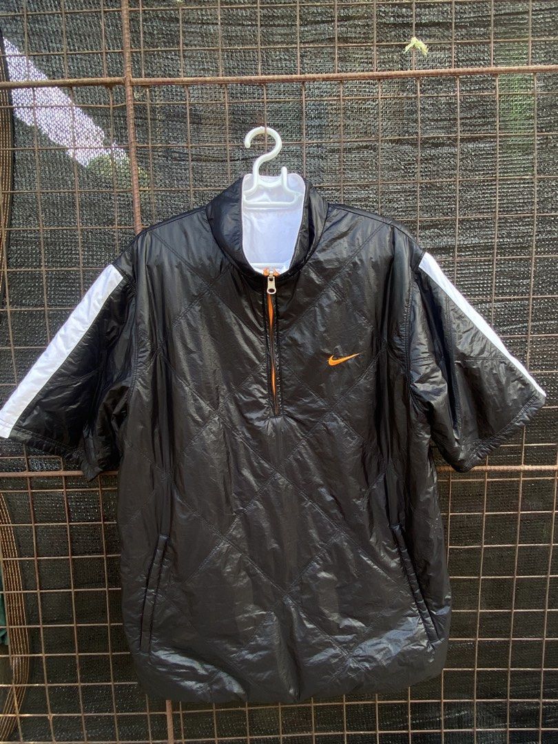 Nike Reversible Short Sleeve Jacket Black White Orange (Category: Coats, Jackets and Outerwear) located in Balanga. Submitted by vincentyy697259 (Listing ID 1446538863, Image 2). Description: - Reversible Nike Jacket - Size: Large (L) - Side 1: Black with quilted pattern and orange accents - Side 2: White with orange zipper - Short sleeves - Ideal for layering or as a light jacket.