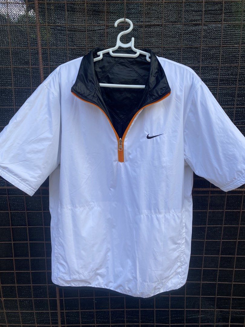 Nike Reversible Short Sleeve Jacket Black White Orange (Category: Coats, Jackets and Outerwear) located in Balanga. Submitted by vincentyy697259 (Listing ID 1446538863, Image 3). Description: - Reversible Nike Jacket - Size: Large (L) - Side 1: Black with quilted pattern and orange accents - Side 2: White with orange zipper - Short sleeves - Ideal for layering or as a light jacket.