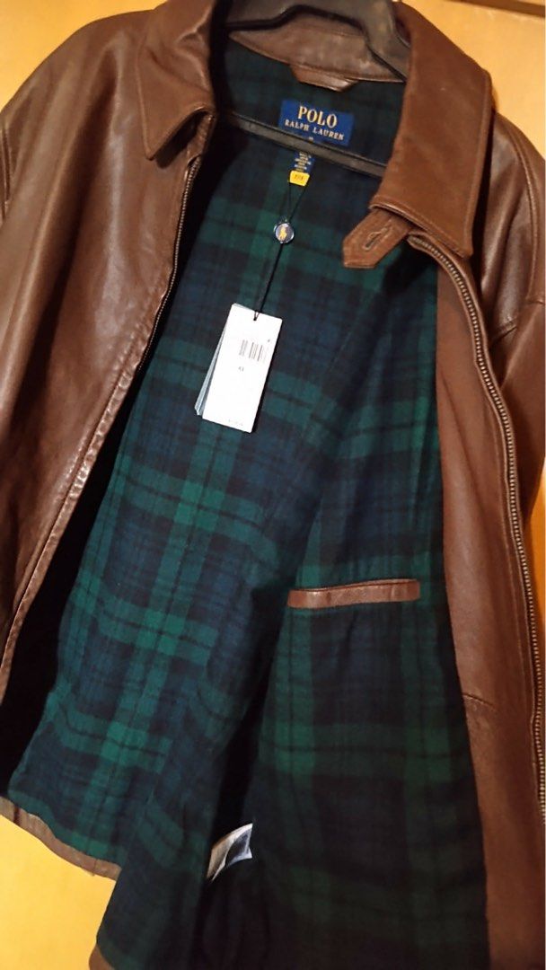NWT Polo Ralph Lauren Brown Leather Jacket (Category: Coats, Jackets and Outerwear) located in Manila. Submitted by annann1003 (Listing ID 1446616488, Image 3). Description: - Classic brown leather jacket by Polo Ralph Lauren - Warm green and navy plaid lining - Zip-up front with two side pockets - Clean, simple back design - Ideal for cooler weather - Brand new with tags still attached -Retails for $700.