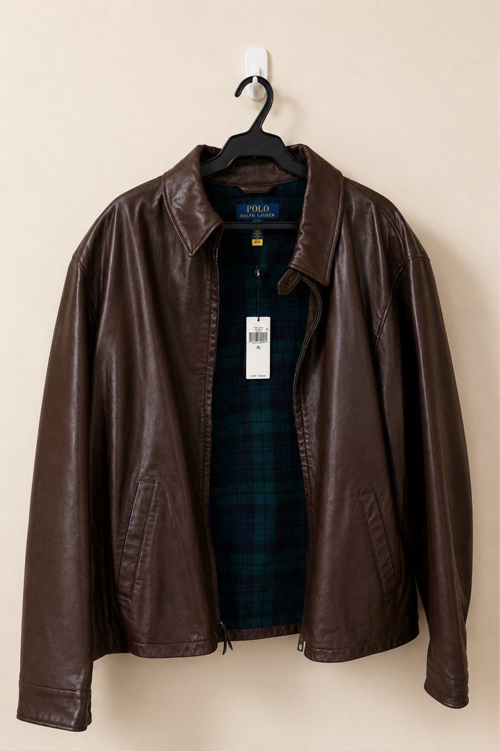 NWT Polo Ralph Lauren Brown Leather Jacket (Category: Coats, Jackets and Outerwear) located in Manila. Submitted by annann1003 (Listing ID 1446616488, Image 1). Description: - Classic brown leather jacket by Polo Ralph Lauren - Warm green and navy plaid lining - Zip-up front with two side pockets - Clean, simple back design - Ideal for cooler weather - Brand new with tags still attached -Retails for $700.