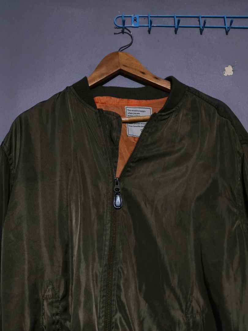 Olive Green MA-1 Style Bomber Jacket (Category: Coats, Jackets and Outerwear) located in Marikina City. Submitted by thebasement_ (Listing ID 1446576037, Image 1). Description: 24x32 - Classic olive green bomber jacket - Vibrant orange lining inside - Secure front zipper closure - Convenient pocket on the sleeve - Ideal for everyday casual wear - Estimated size: Large (L) .