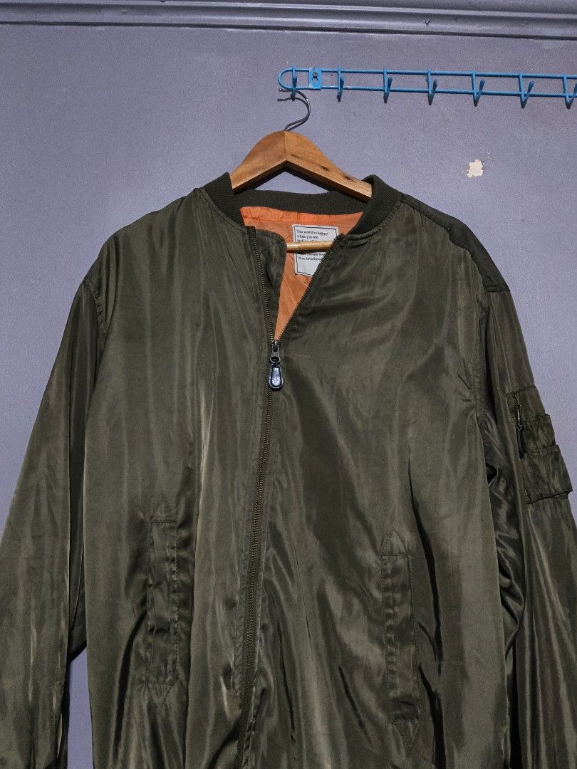 Olive Green MA-1 Style Bomber Jacket (Category: Coats, Jackets and Outerwear) located in Marikina City. Submitted by thebasement_ (Listing ID 1446576037, Image 2). Description: 24x32 - Classic olive green bomber jacket - Vibrant orange lining inside - Secure front zipper closure - Convenient pocket on the sleeve - Ideal for everyday casual wear - Estimated size: Large (L) .
