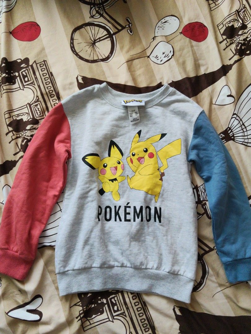 Pokemon Pikachu Sweatshirt Grey Blue Red Sleeves Size S (Category: Babies & Kids Fashion) located in Batangas. Submitted by ms.d_preloveditems (Listing ID 1446549521, Image 1). Description: - Official Pokemon merchandise - Grey sweatshirt with iconic Pikachu graphic - Contrasting red and blue sleeves - Size S (fits height 130cm, chest 66cm, waist 60cm) - Perfect for any Pokemon fan! - Easy care: Machine washable (do not tumble dry) - Made in Chin