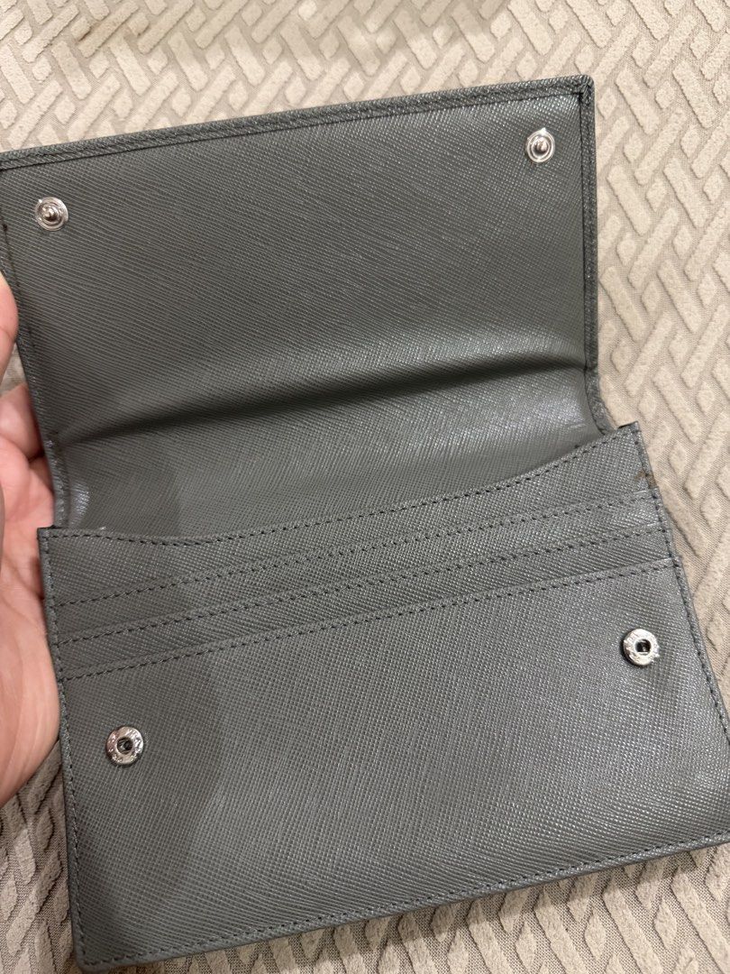 Prada Saffiano Leather Wallet Grey (Category: Luxury Bags & Wallets) located in Cebu City. Submitted by myclosettoyours_cebu (Listing ID 1446690564, Image 2). Description: - Authentic Prada Wallet - Made in Italy - Saffiano Leather - Color: Grey - Snap Closure - Multiple Card Slots With normal signs of use hence selling very slow .
