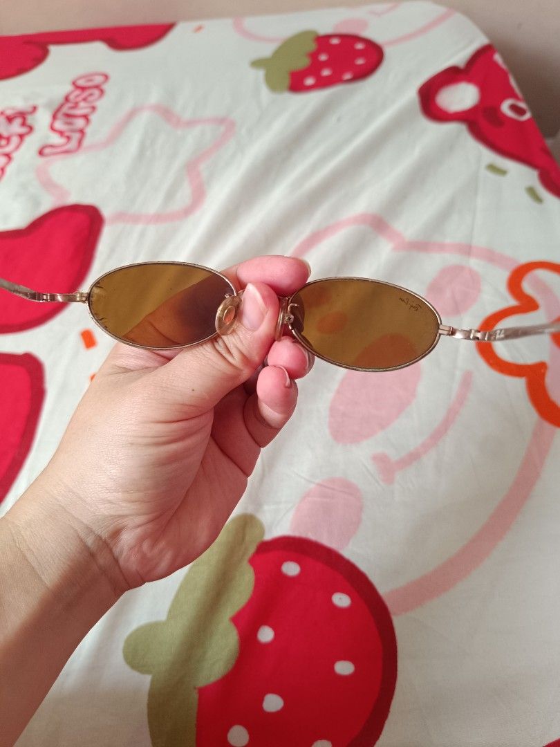 Ray-Ban Oval Sunglasses Amber Lenses (Category: Sunglasses & Eyewear) located in Las Pinas. Submitted by anneguevarra0905 (Listing ID 1446603602, Image 3). Description: - Authentic Ray-Ban oval sunglasses - Amber-tinted lenses for clear vision - Thin, lightweight metal frame - Visible Ray-Ban logo on the arm - Ideal for sunny weather - Feel free to ask any questions!.