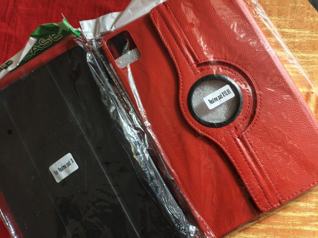 Red & Black Flip Case for Realme Pad Mini (Category: Cases & Sleeves) located in Valenzuela. Submitted by emotika (Listing ID 1446714299, Image 2). Description: - Set includes a red flip case (brand new) black case (used) - Red case features a 360-degree rotating stand for versatile viewing angles. - brand new - Both cases offer excellent protection against scratch and bumps - Ideal for watching videos, browsing, or typing..