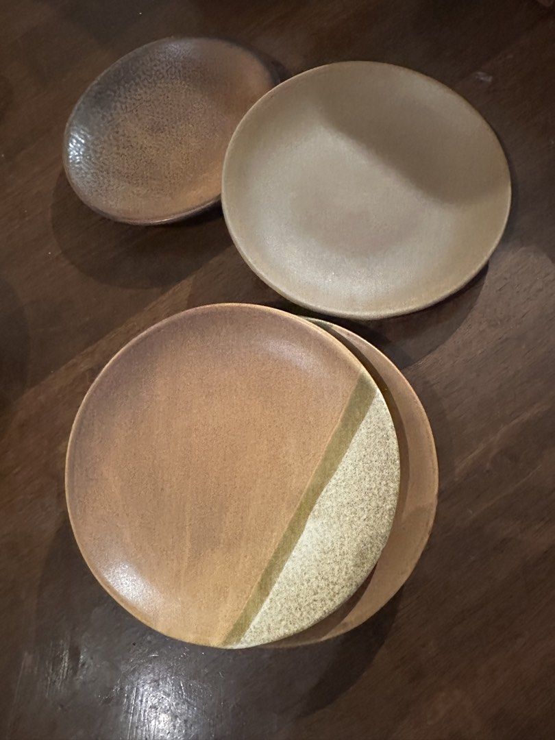 Set of 4 Ceramic Plates - Earth Tones (Category: Dinnerware & Cutlery) located in Manila. Submitted by kaitdeclutters (Listing ID 1446547722, Image 3). Description: - Set of 4 unique ceramic plates - Earthy tones with a rustic, handmade aesthetic - Two larger plates feature a gradient brown finish - One larger plate has a distinctive split design with textured lighter section - One smaller plate showcases a speckled dark brown finish - Ideal for 