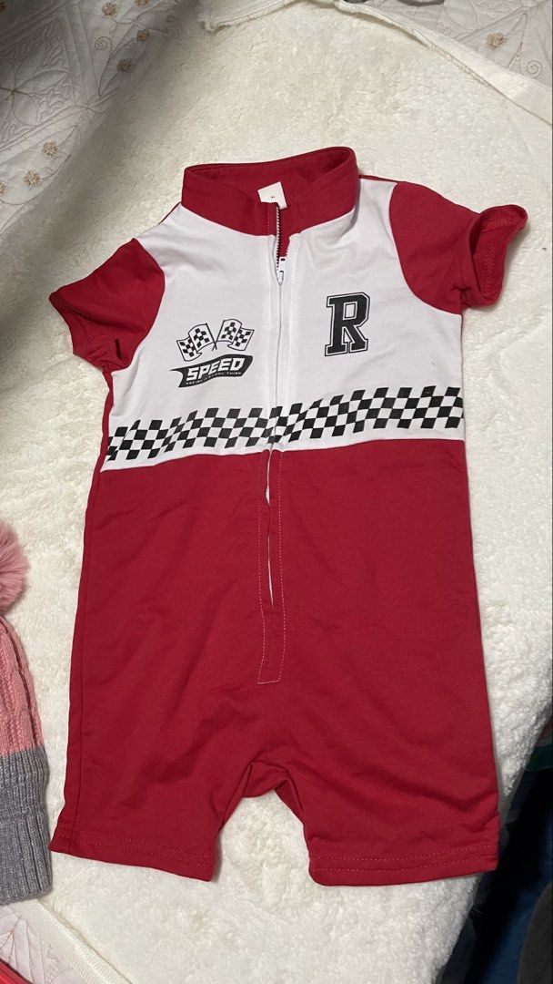 SHEIN Baby Racing Romper Size 2-3Y (Category: Babies & Kids Fashion) located in Manila. Submitted by imeejoy07 (Listing ID 1446590118, Image 2). Description: Location: PACO MANILA Cute red and white racing-themed romper for your little one. Features a zipper front and a checkered flag design. The letter 'R' is on the chest. Back is solid red. Made by SHEIN. Size 2-3 years..