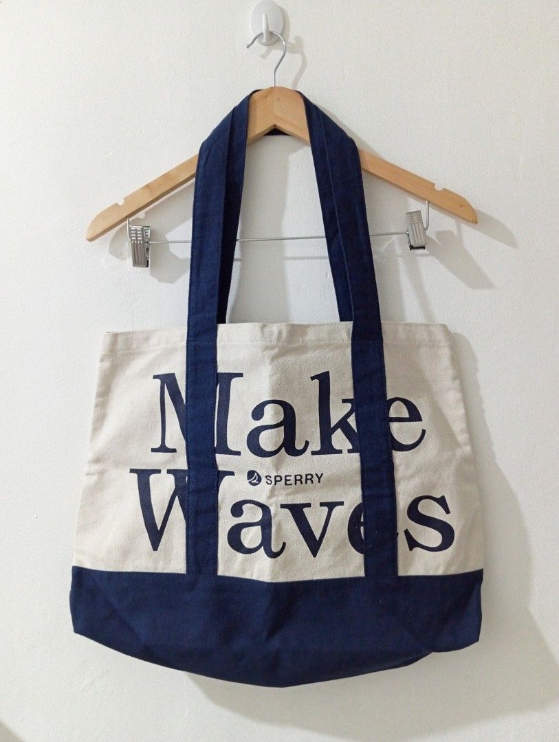 Sperry "Make Waves" Canvas Tote Bag (Category: Tote Bags) located in Manila. Submitted by cococlo_ (Listing ID 1446675131, Image 1). Description: - Sperry Canvas Tote Bag - Navy blue with 'Make Waves' slogan - Durable canvas material - Ideal for everyday use, beach trips, and carrying essentials - Classic and simple design.