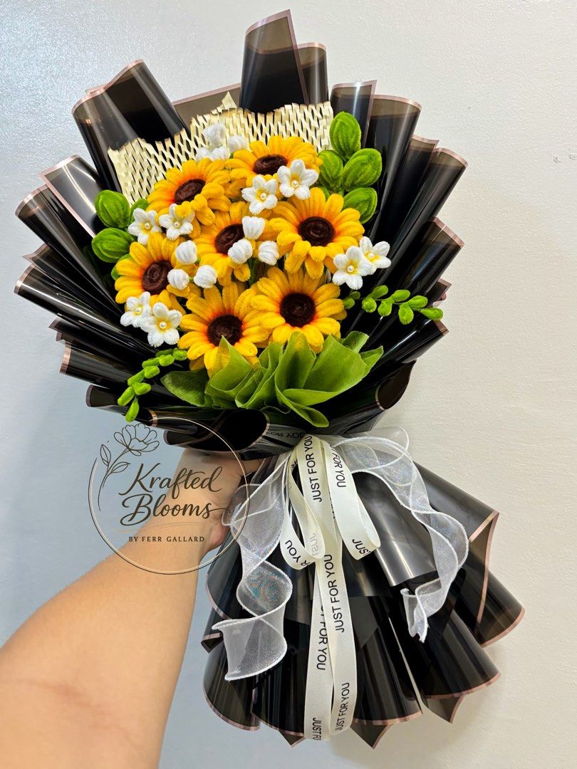 Sunflower Fuzzy Wire Bouquet (Category: Flowers & Bouquets) located in Taguig. Submitted by ferrgallardsegunda (Listing ID 1446710590, Image 1). Description: - Beautiful crochet bouquet featuring sunflowers and small white flowers. - Wrapped in elegant black and brown paper. - Adorned with a white ribbon that says 'Just For You'. - Ideal for gifts or as a charming decoration. - Crafted with care by Krafted Blooms by Ferr Gallard..