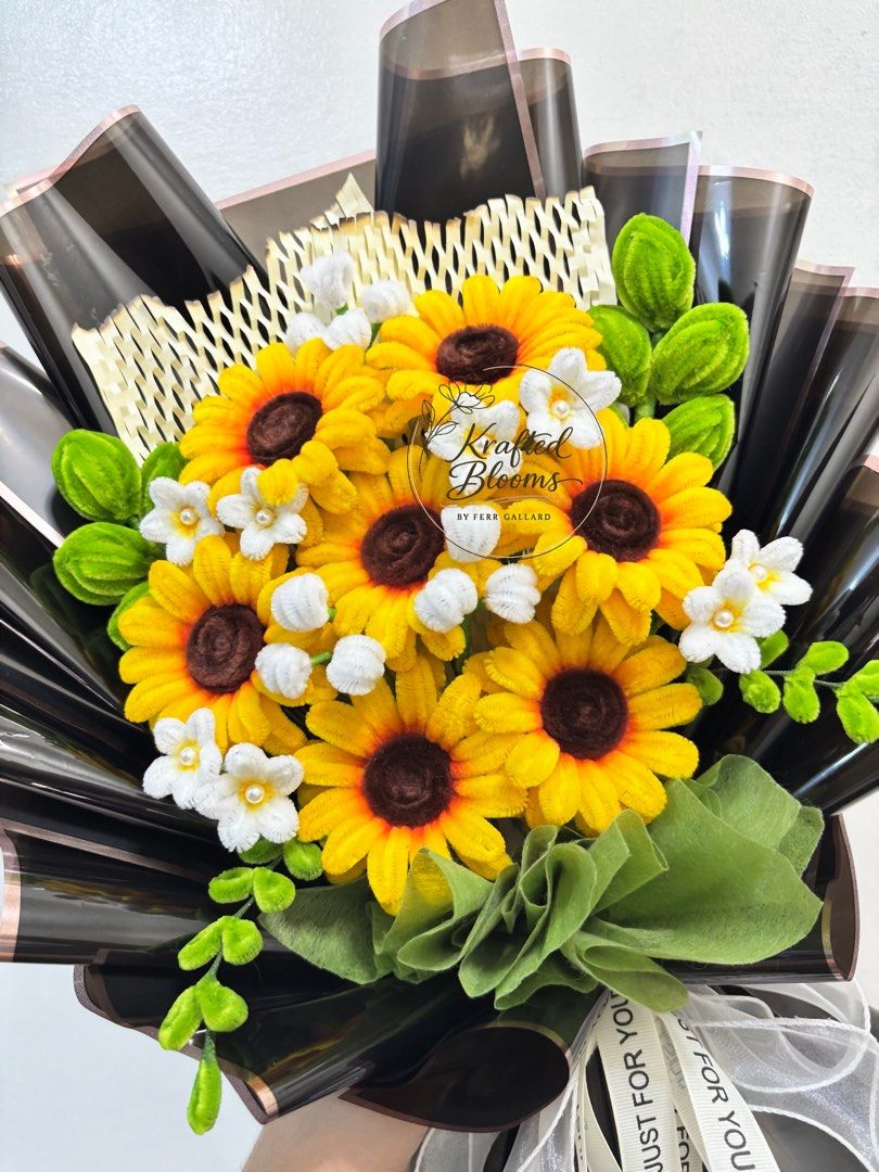 Sunflower Fuzzy Wire Bouquet (Category: Flowers & Bouquets) located in Taguig. Submitted by ferrgallardsegunda (Listing ID 1446710590, Image 2). Description: - Beautiful crochet bouquet featuring sunflowers and small white flowers. - Wrapped in elegant black and brown paper. - Adorned with a white ribbon that says 'Just For You'. - Ideal for gifts or as a charming decoration. - Crafted with care by Krafted Blooms by Ferr Gallard..