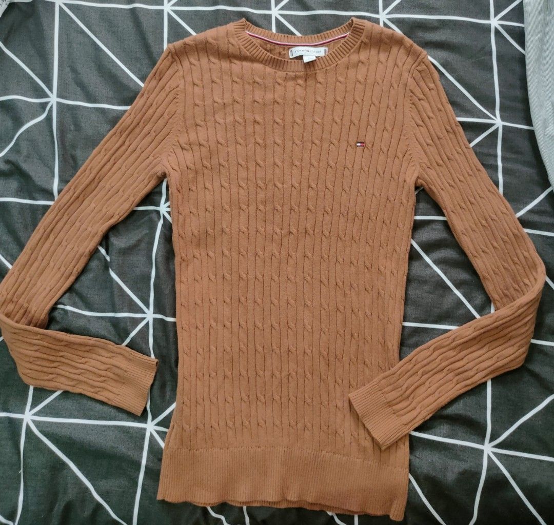 Tommy Hilfiger Cable Knit Sweater Top (Category: Longsleeves) located in Manila. Submitted by thatstyle (Listing ID 1446556679, Image 1). Description: - Brand: Tommy Hilfiger - Color: Brown - Material: Cable knit - Sleeve Length: long sleeves - Features: Small Tommy Hilfiger flag logo on chest - Style: Comfortable and stylish, great for layering or wearing on its own.