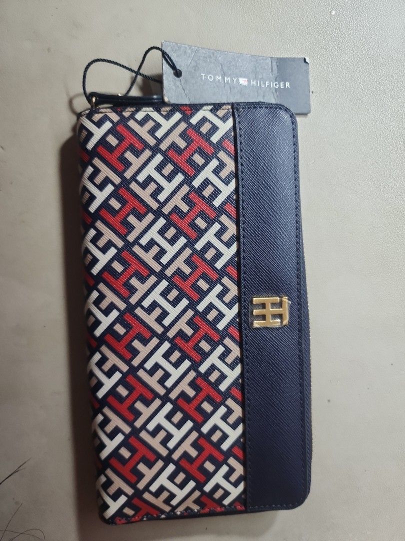 Tommy Hilfiger Zip Around Wallet (Category: Wallets & Card holders) located in Quezon City. Submitted by rdl09 (Listing ID 1446702317, Image 1). Description: - Authentic Tommy Hilfiger wallet - Signature TH monogram pattern - Secure zip-around closure - Multiple interior card slots - Internal zippered compartment for coins/change - Elegant gold hardware - Comes with original tag.