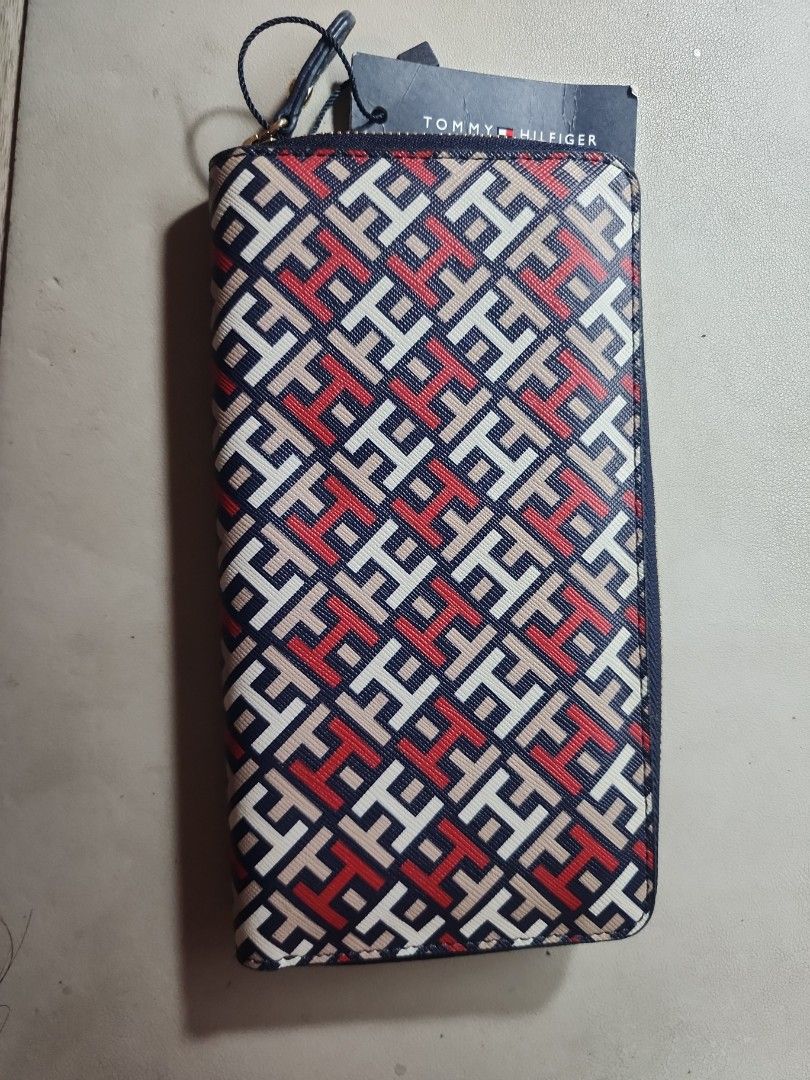 Tommy Hilfiger Zip Around Wallet (Category: Wallets & Card holders) located in Quezon City. Submitted by rdl09 (Listing ID 1446702317, Image 3). Description: - Authentic Tommy Hilfiger wallet - Signature TH monogram pattern - Secure zip-around closure - Multiple interior card slots - Internal zippered compartment for coins/change - Elegant gold hardware - Comes with original tag.