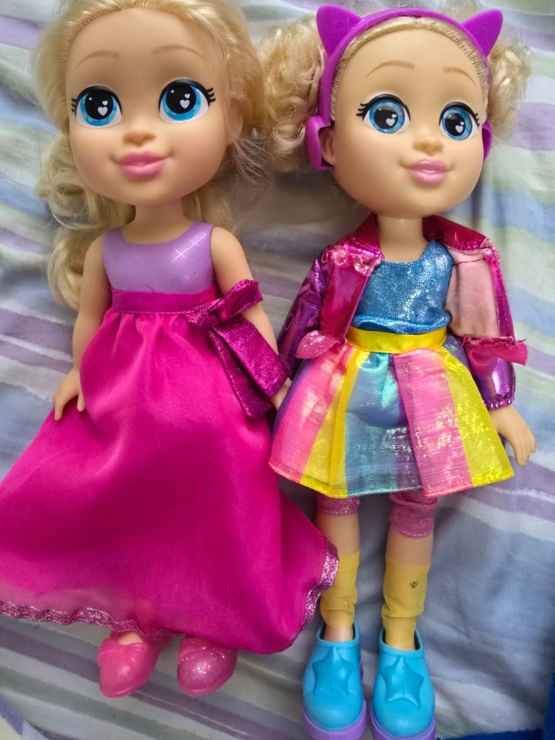Two Diana Dolls with Outfits (Category: Kids Toys) located in Quezon City. Submitted by mariescloset2020 (Listing ID 1446626065, Image 1). Description: - Two talking dolls ready for a new home. - Doll 1: Rainbow dress, purple cat ears headband, blonde hair, blue eyes. - Doll 2: Bright pink dress, blonde hair, blue eyes. - Ideal for imaginative play and gifting..