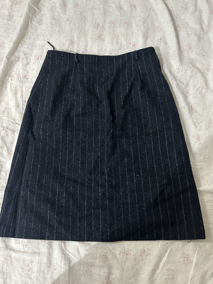 Wanko Pinstripe A-Line Skirt (Category: Skirts) located in Mandaluyong City. Submitted by slickestb (Listing ID 1446639985, Image 1). Description: - Dark grey skirt with white pinstripes - A-line cut - Estimated size 36 - Lined interior - Versatile for work or casual outfits - Classic and simple design.