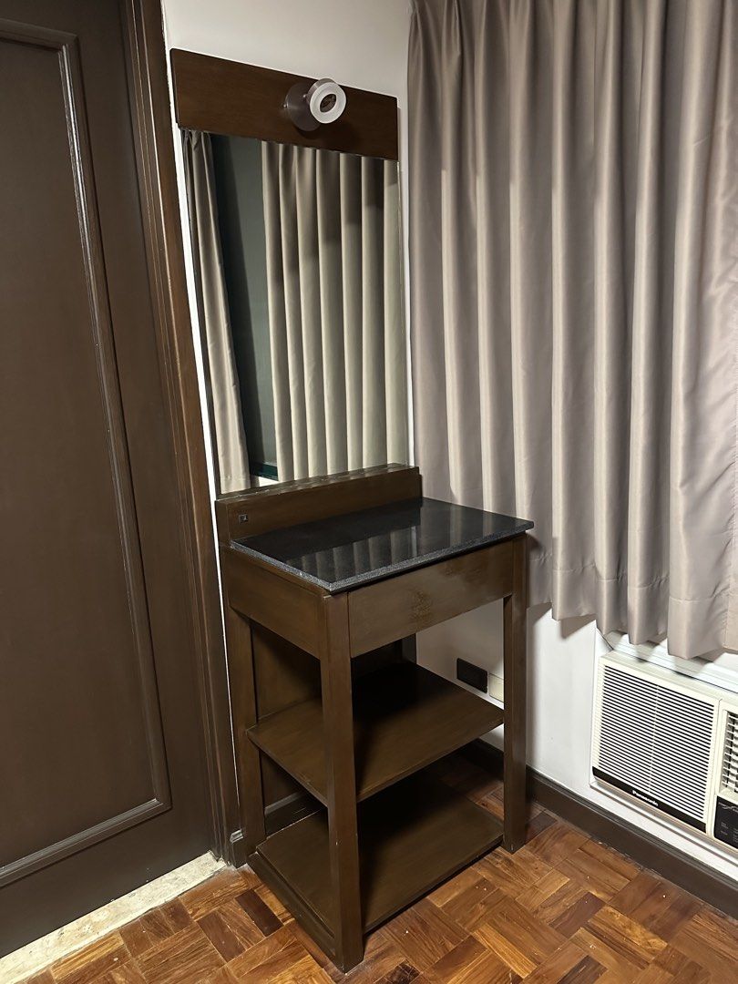 Wooden Vanity Table with Granite Top and Mirror (Category: Tables & Sets) located in Taguig. Submitted by kristeta85 (Listing ID 1446591433, Image 1). Description: - Compact wooden vanity table - Features a dark granite top - Two open shelves for storage - Includes a mirror above the top - Pull-out drawer for additional storage - Ideal for small spaces - 60cm W x 47cm D x 90cm H of table - 193cm H total height with mirror - RFS: Redecorating - Pi