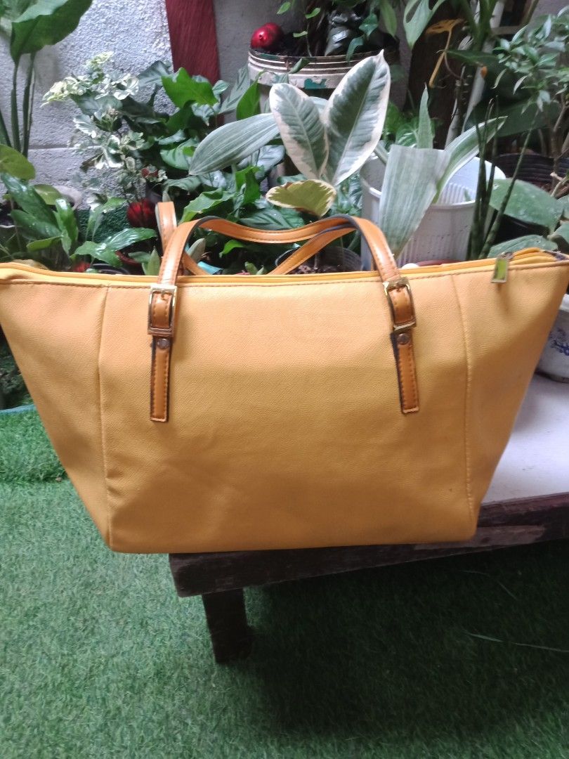 Yellow Canvas Tote Bag with Leather Accents (Category: Tote Bags) located in Manila. Submitted by jessyaveri (Listing ID 1446541576, Image 2). Description: - Durable yellow canvas tote bag - Genuine leather handles and strap details - Secure zipper closure for top access - Interior zippered pocket and slip pocket for organization - Spacious main compartment for all your essentials - Ideal for everyday errands or weekend getaways - Comfortable and