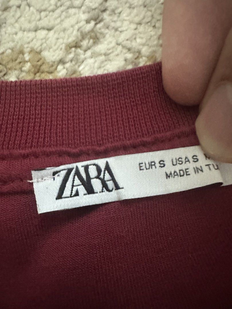 ZARA Burgundy Sweatshirt with Embossed Text - Small (Category: Tshirts & Polo Shirts ) located in Quezon City. Submitted by closetrm131 (Listing ID 1446618107, Image 3). Description: - Brand: ZARA - Color: Burgundy - Design: Embossed text on front: 'THE ENDLESS ECHOES OF THE UNIVERSE' - Sleeves: Short - Neckline: Crew neck - Material: Made in Turkey - Size: S (EUR S, USAS M) - Style: Casual wear.