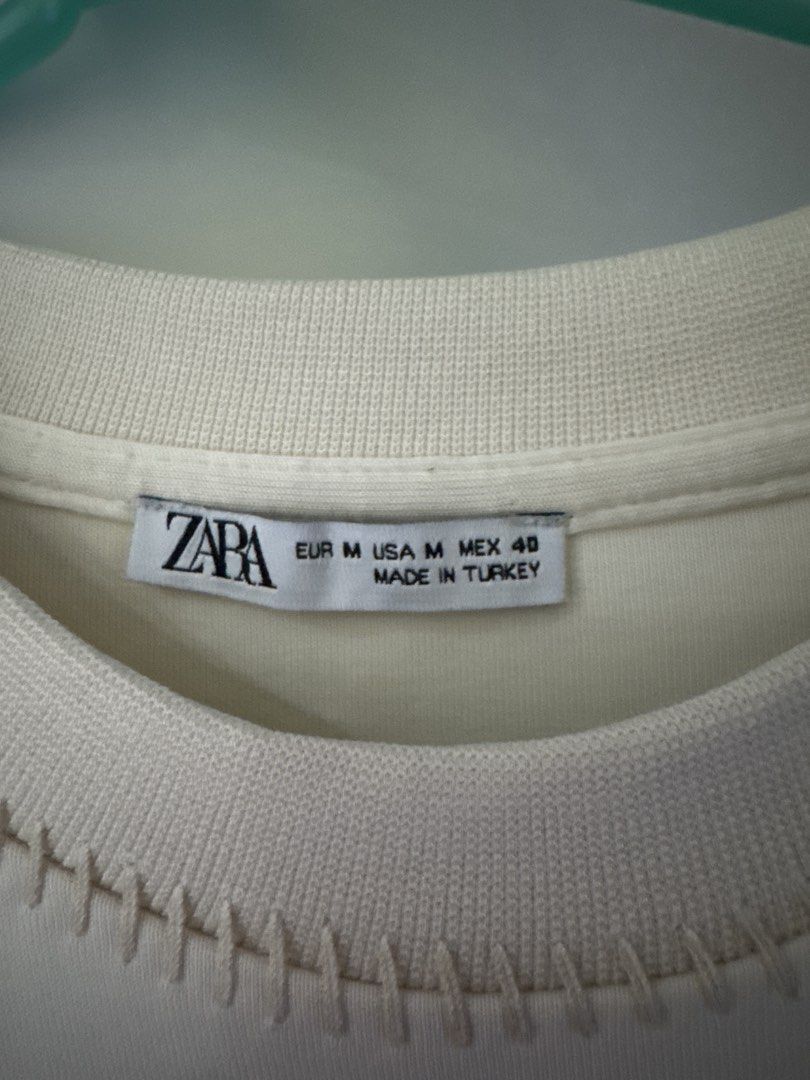 ZARA Cream Oversized T-Shirt (Category: Others Tops) located in Binan City. Submitted by mituz (Listing ID 1446544927, Image 2). Description: - Cream colored t-shirt from ZARA - Size: Medium - Fit: Relaxed, oversized - Features: Unique stitching detail on neckline and sleeves - Origin: Made in Turkey - Style: Essential wardrobe basic.