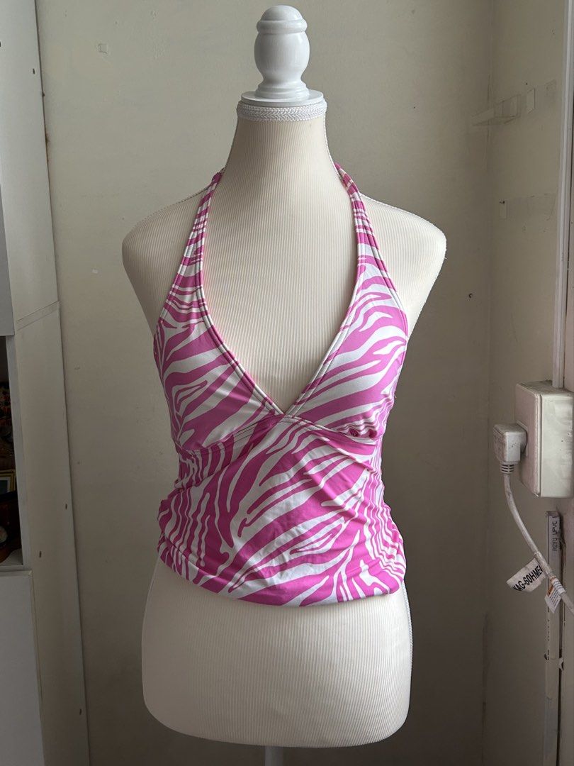 2000s Michael Kors Pink Zebra Print Halter Top (Category: Sleeveless) located in Pasig City. Submitted by declutterwithme_agb (Listing ID 1441777756, Image 2). Description: - Adorable pink and white zebra print halter top. - Halter neck with ties at the back. - Features ruched detailing on the sides. - Embellished with silver Michael Kors hardware at the hem. - Ideal for beach or pool wear..