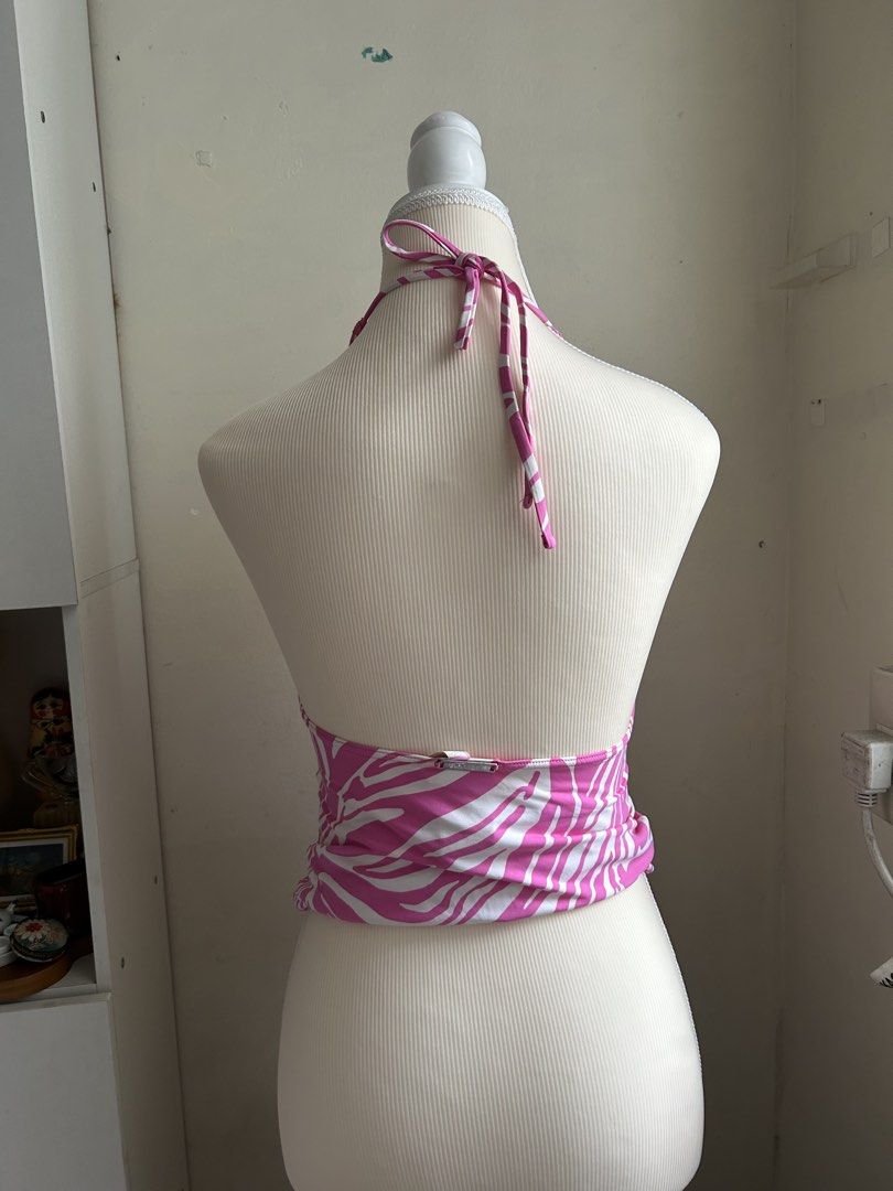 2000s Michael Kors Pink Zebra Print Halter Top (Category: Sleeveless) located in Pasig City. Submitted by declutterwithme_agb (Listing ID 1441777756, Image 3). Description: - Adorable pink and white zebra print halter top. - Halter neck with ties at the back. - Features ruched detailing on the sides. - Embellished with silver Michael Kors hardware at the hem. - Ideal for beach or pool wear..