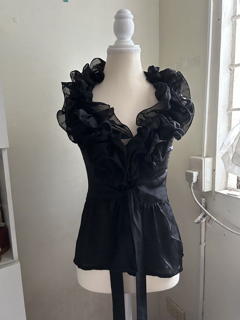 2000s Vintage Black Ruffle Sheer V-Neck Top (Category: Blouses) located in Pasig City. Submitted by declutterwithme_agb (Listing ID 1441776641, Image 2). Description: - Elegant black sheer top - Delicate ruffles around the neckline - Adjustable tie detail at the waist - Estimated size: 4 - Material: 100% Polyester - Care instructions available on tag - Ideal for evening wear or a night out.