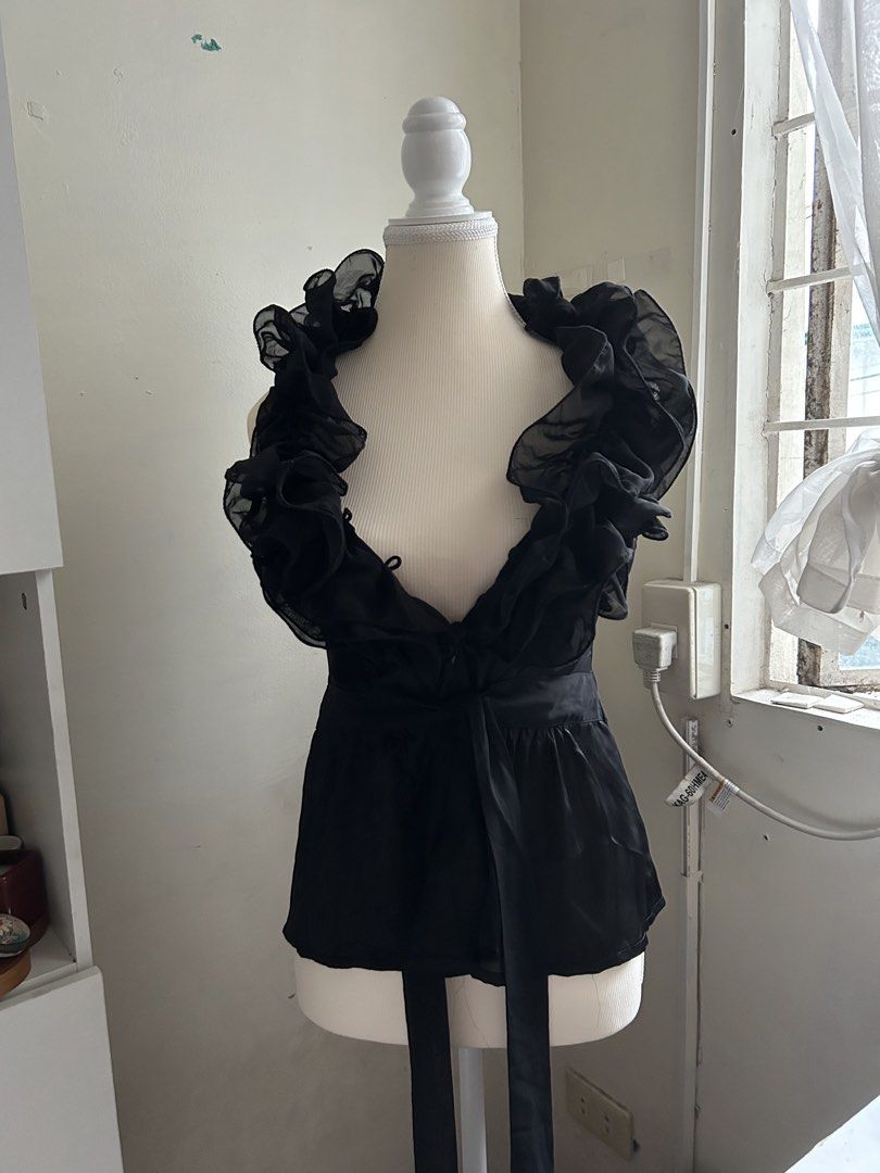2000s Vintage Black Ruffle Sheer V-Neck Top (Category: Blouses) located in Pasig City. Submitted by declutterwithme_agb (Listing ID 1441776641, Image 3). Description: - Elegant black sheer top - Delicate ruffles around the neckline - Adjustable tie detail at the waist - Estimated size: 4 - Material: 100% Polyester - Care instructions available on tag - Ideal for evening wear or a night out.