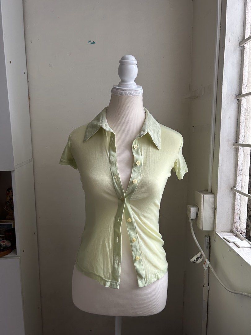 3 FOR 200 Miss Selfridge Light Green Button-Up Collared Top (Category: Blouses) located in Pasig City. Submitted by declutterwithme_agb (Listing ID 1441777875, Image 2). Description: - Light green collared top - Brand: Miss Selfridge - Short sleeves - Button-up front - Fabric has a slight sheen - Can be worn alone or layered - Suitable for casual or dressed-up occasions.