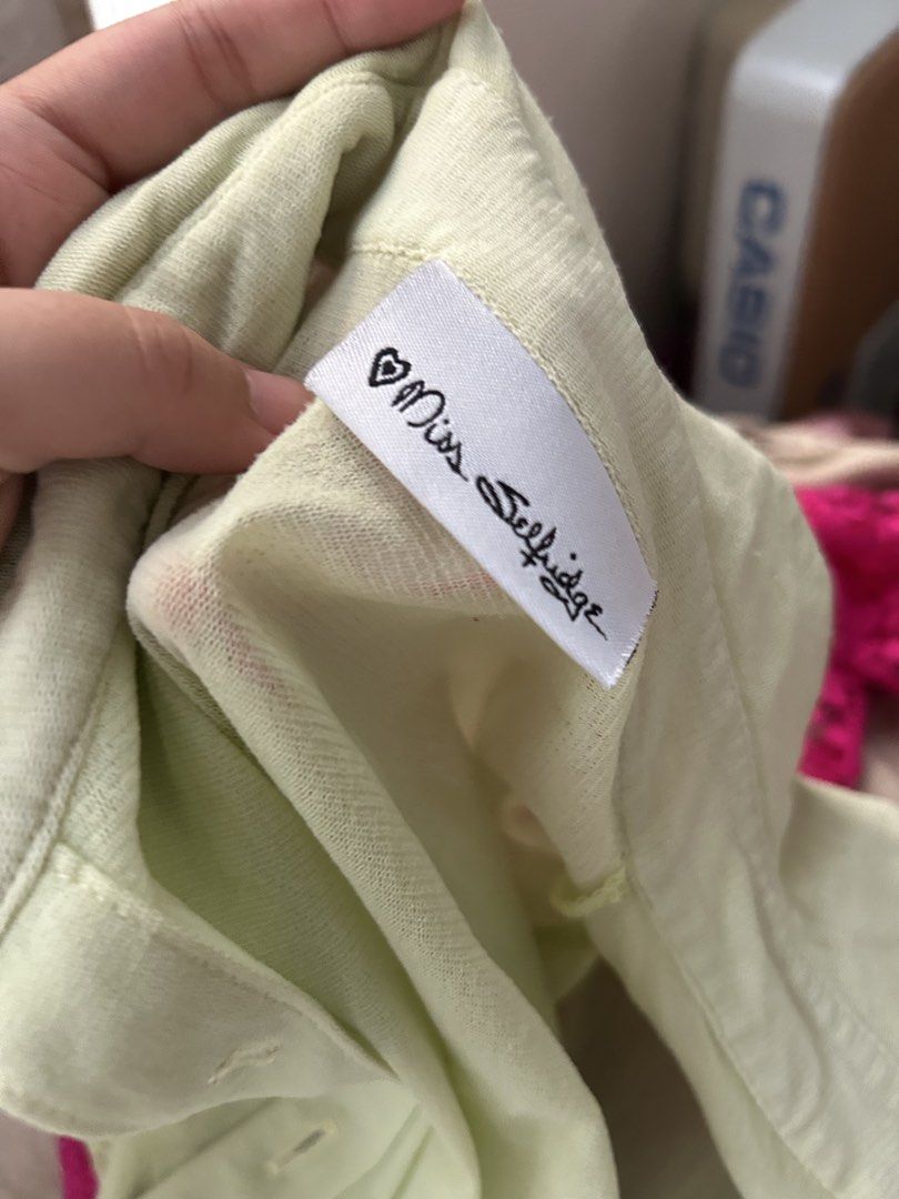 3 FOR 200 Miss Selfridge Light Green Button-Up Collared Top (Category: Blouses) located in Pasig City. Submitted by declutterwithme_agb (Listing ID 1441777875, Image 3). Description: - Light green collared top - Brand: Miss Selfridge - Short sleeves - Button-up front - Fabric has a slight sheen - Can be worn alone or layered - Suitable for casual or dressed-up occasions.